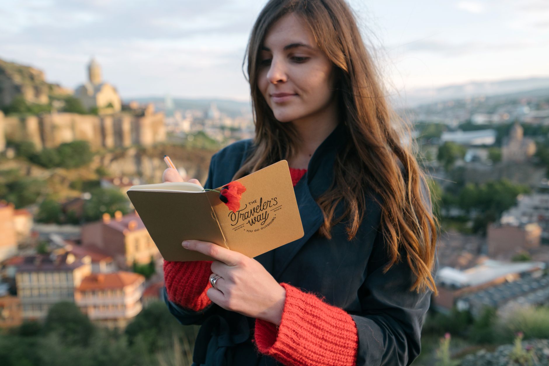 Travel journalist writing in journal